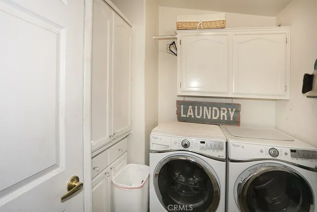 a view of a hallway with washer and dryer