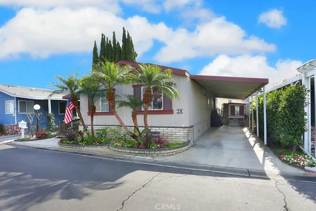 a front view of a house with a yard and potted plants
