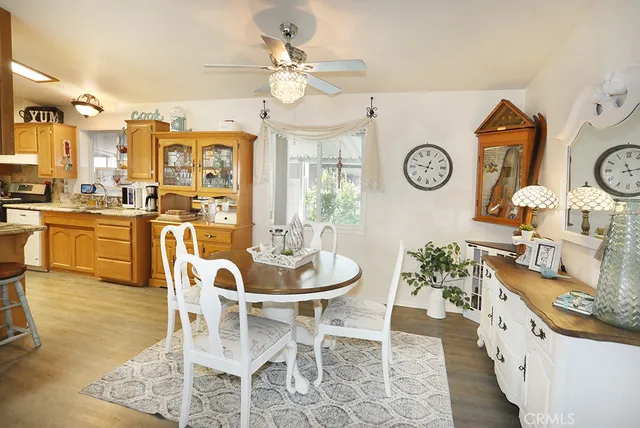 a view of a dining room and kitchen with furniture large window and wooden floor
