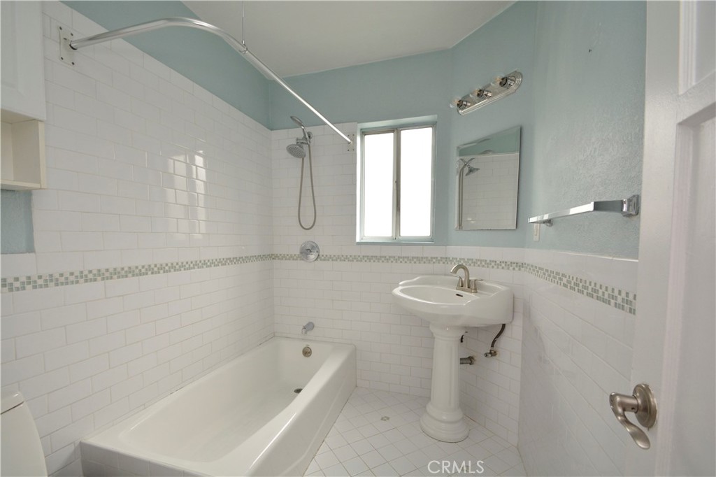 12301 Rives Avenue Downey, CA 90242 - Photo 13 of 20 a bathroom with a sink mirror and a bathtub