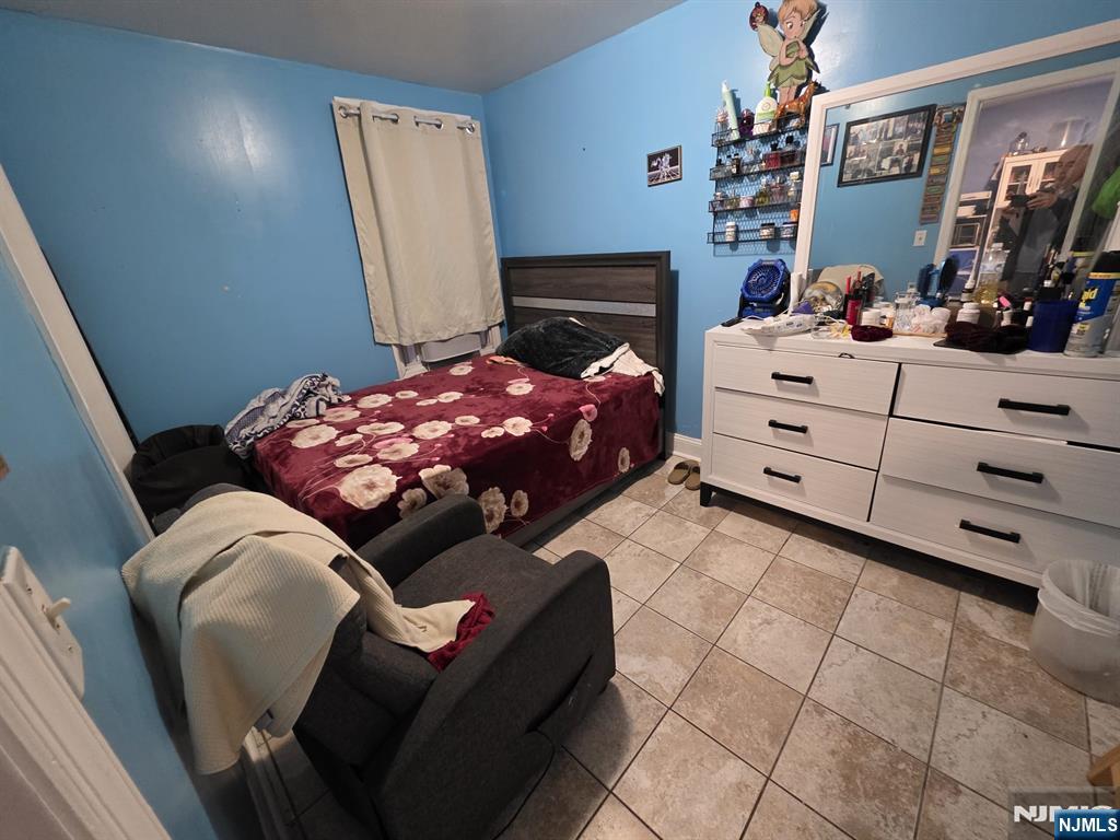 32 Elm Street Paterson, NJ 07501 - Photo 11 of 20 a bedroom with a bed and a mirror