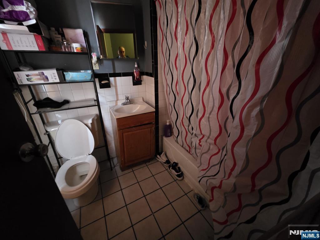 32 Elm Street Paterson, NJ 07501 - Photo 13 of 20 a bathroom with a toilet and a sink