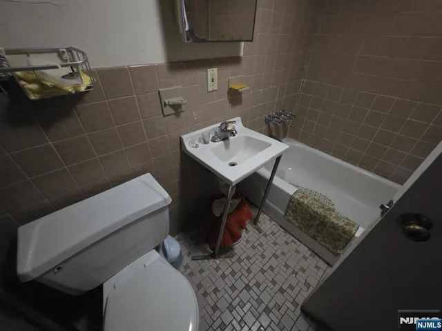 a bathroom with a sink toilet and a mirror