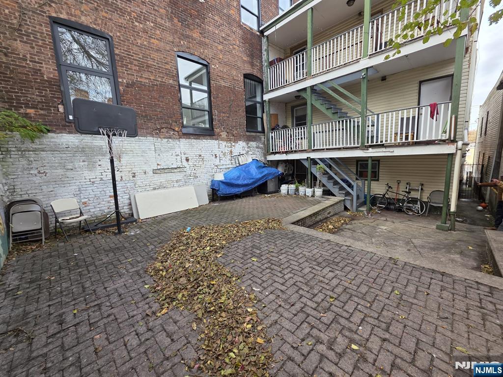 32 Elm Street Paterson, NJ 07501 - Photo 20 of 20 a backyard of a house with table and chairs
