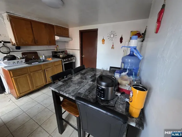 a kitchen with a stove and a refrigerator