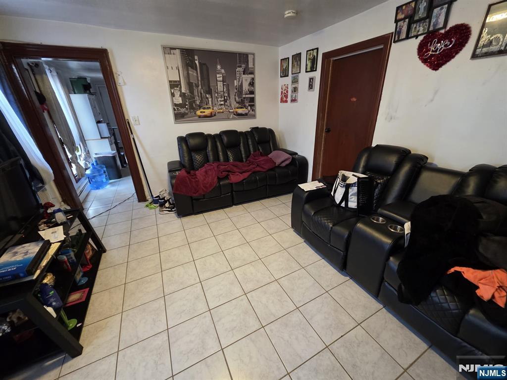 32 Elm Street Paterson, NJ 07501 - Photo 5 of 20 a living room with furniture and a flat screen tv