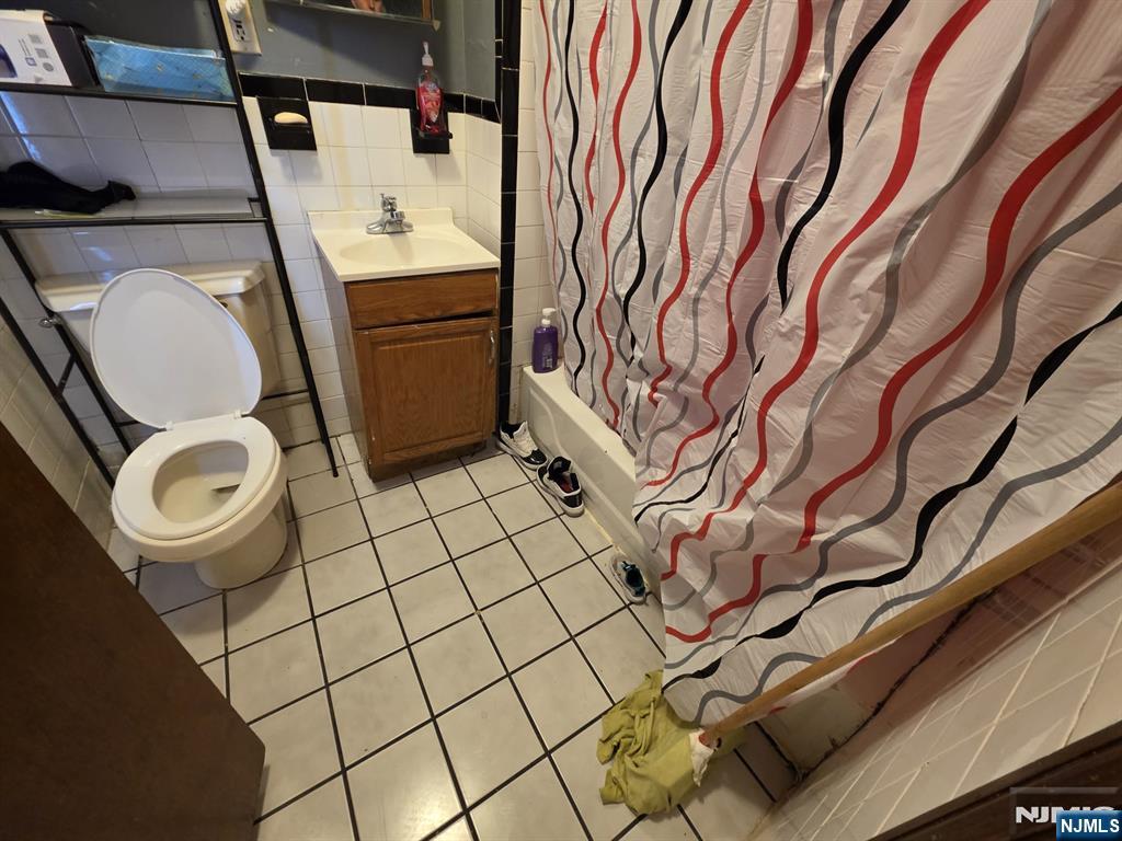 32 Elm Street Paterson, NJ 07501 - Photo 7 of 20 a bathroom with a sink and mirror