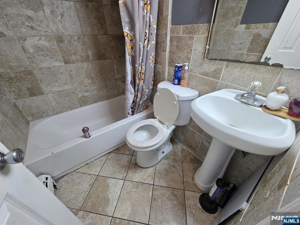 32 Elm Street Paterson, NJ 07501 - Photo 10 of 20 a bathroom with a sink toilet and shower