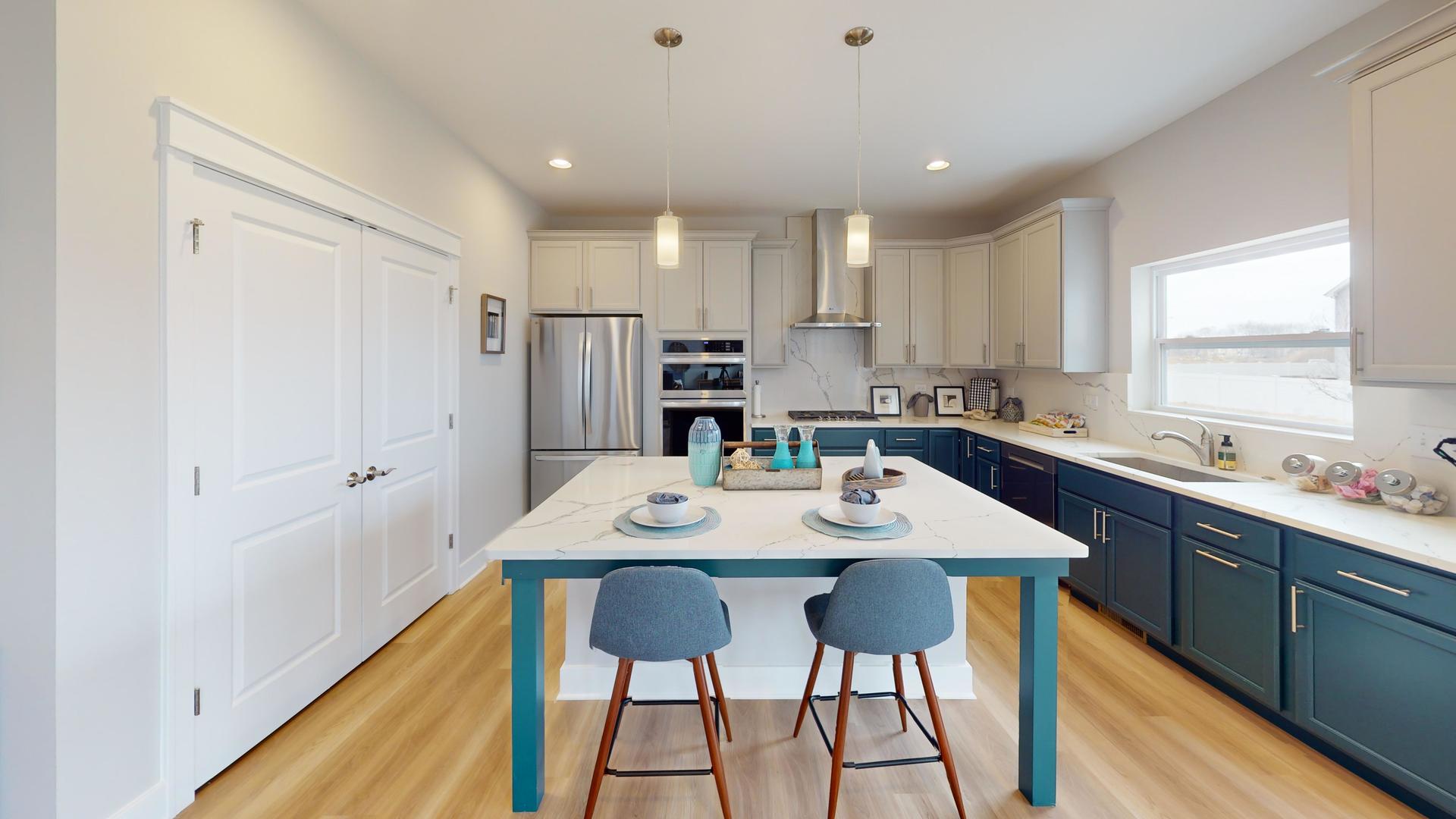 2 Deerpath Road North Aurora, IL 60542 - Photo 2 of 45 a kitchen with stainless steel appliances kitchen island granite countertop a table chairs sink and cabinets