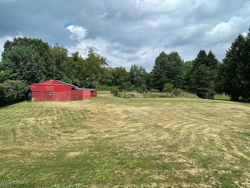 2285 Killian Road Akron, OH 44312 - Photo 27 of 32 View of the rear yard, showing the storage barn and garden space.