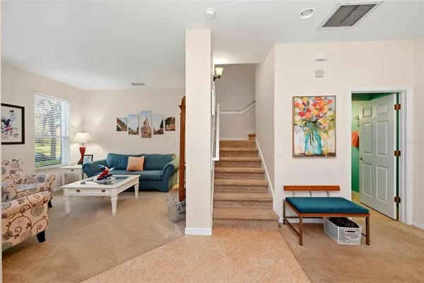a living room with furniture and a stairs