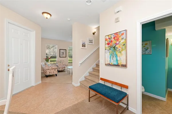 a living room with furniture and a stairs