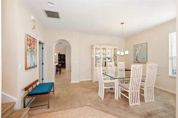 a dining room with furniture and window