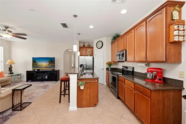 a kitchen with stainless steel appliances a sink a stove and microwave