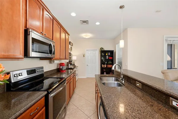 a kitchen with stainless steel appliances granite countertop a sink and cabinets
