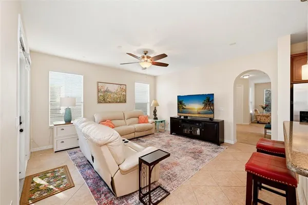a living room with furniture a rug and a book shelf