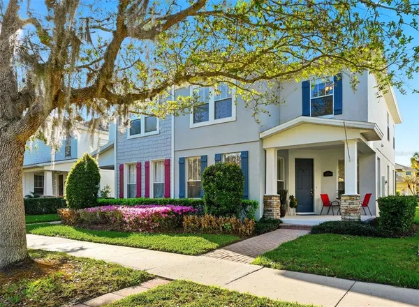 a front view of a house with a garden and plants