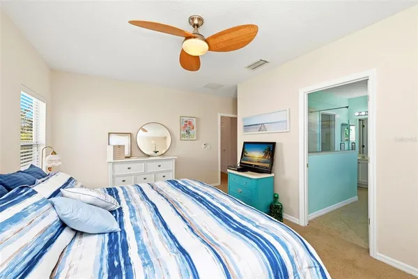 a bathroom with a granite countertop bathtub a double vanity sink and a large mirror