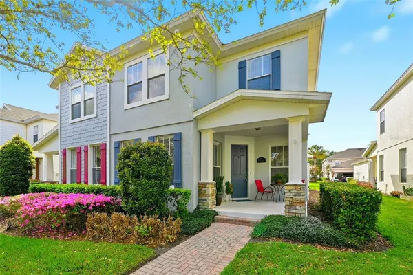 a view of a house with fountain and garden