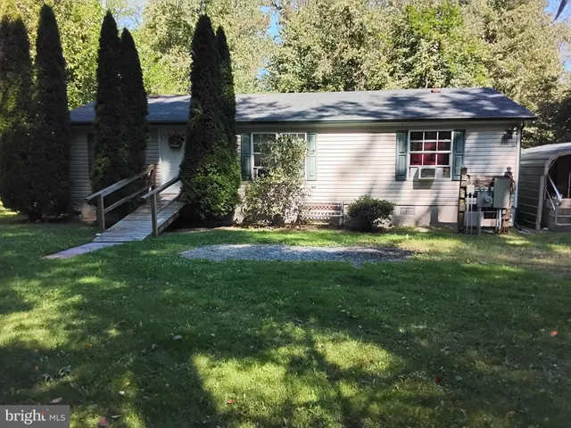 a view of house with backyard and garden