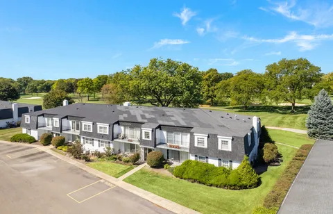 an aerial view of a house with a big yard