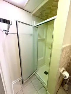 a bathroom with a glass door shower