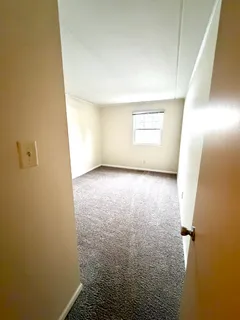 a view of room with window and a door