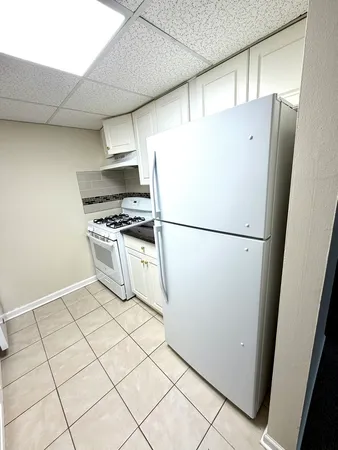 a kitchen with stainless steel appliances a refrigerator sink and cabinets