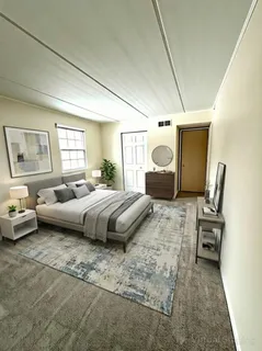 a bedroom with a bed couch and window