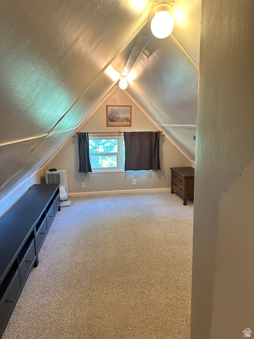 541 300 North Provo, UT 84606 - Photo 32 of 36 Attic space featuring sloped ceilings, recessed windows, and neutral carpeting
