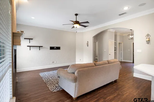 a living room with furniture and a ceiling fan