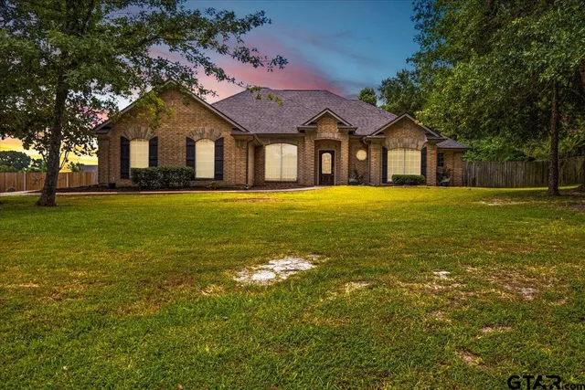 a front view of a house with a big yard