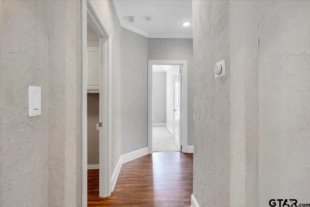 a view of a hallway with wooden floor
