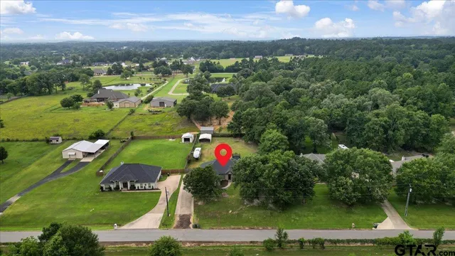 an aerial view of residential houses with outdoor space and swimming pool