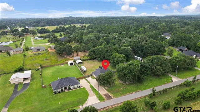 an aerial view of residential houses with outdoor space and lake view