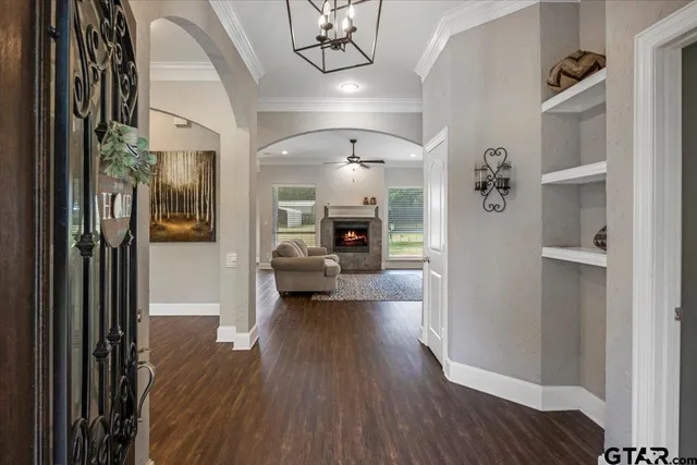 a view of a livingroom with furniture hardwood floor and a ceiling fan