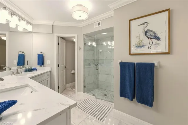a bathroom with a double vanity sink mirror and shower