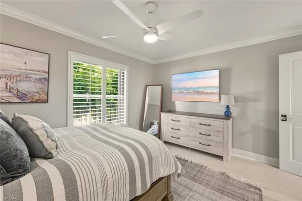 a spacious bedroom with a bed and wooden floor