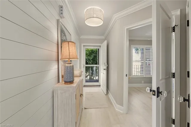 a living room with a bed and a flat screen tv