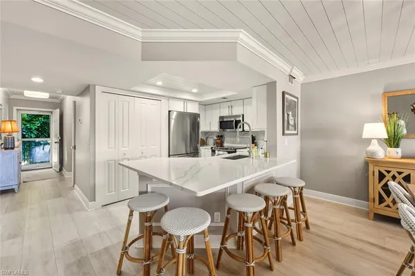 a kitchen with stainless steel appliances granite countertop a refrigerator a stove top oven a sink and dishwasher