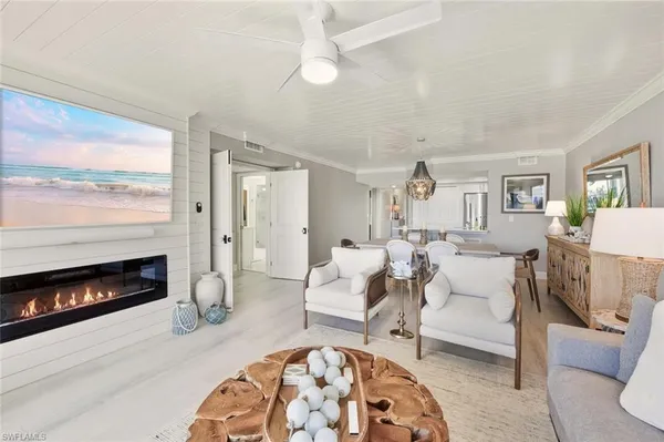 a living room with furniture a fireplace and a large window