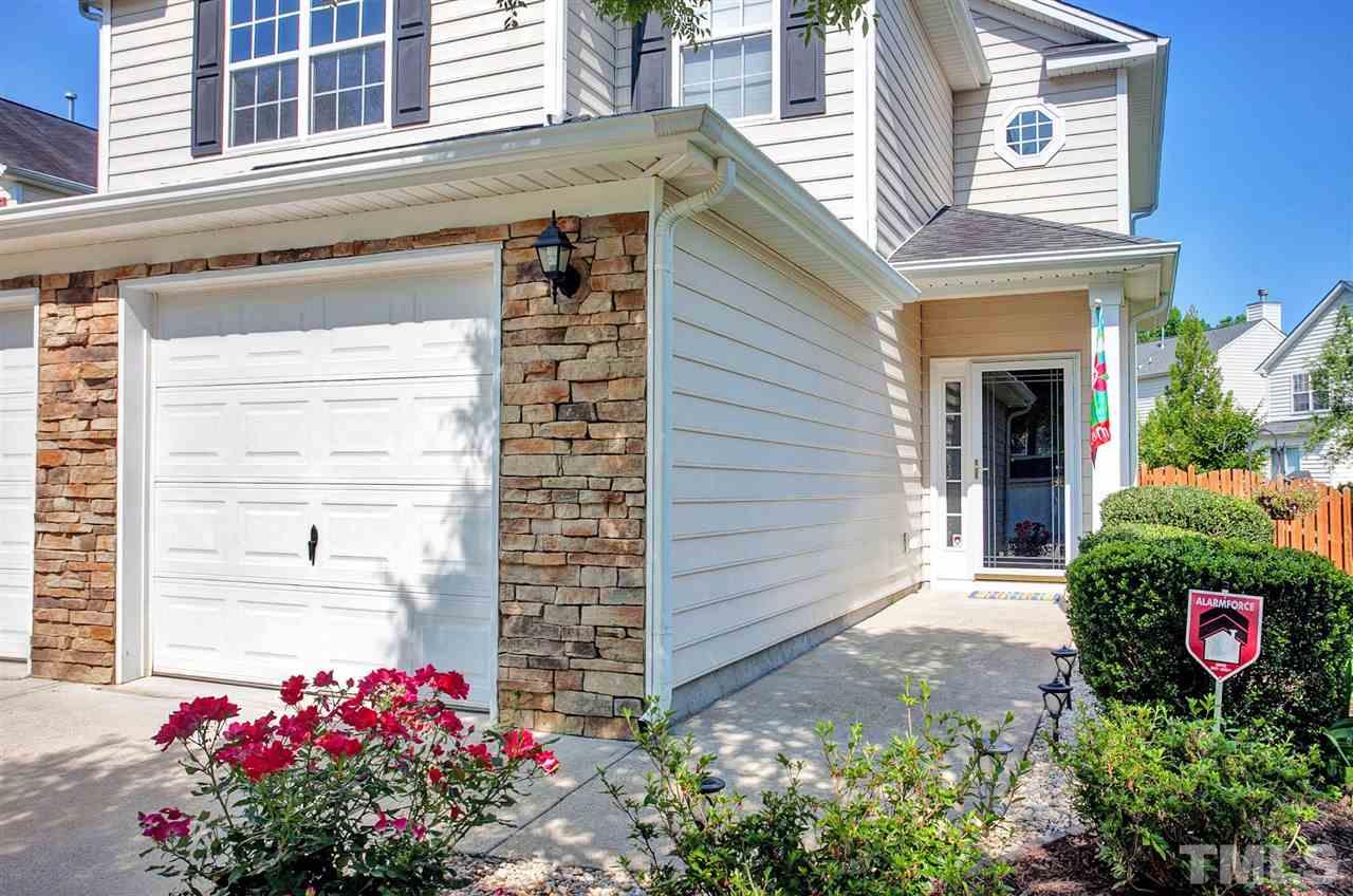 308 Inkster Cove Raleigh, NC 27603 - Photo 2 of 25 a front view of a house with a yard and flowers