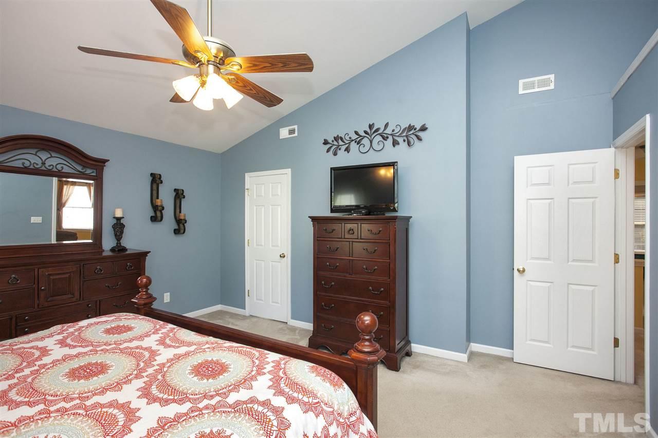 308 Inkster Cove Raleigh, NC 27603 - Photo 12 of 25 a bedroom with a bed and a dresser in it