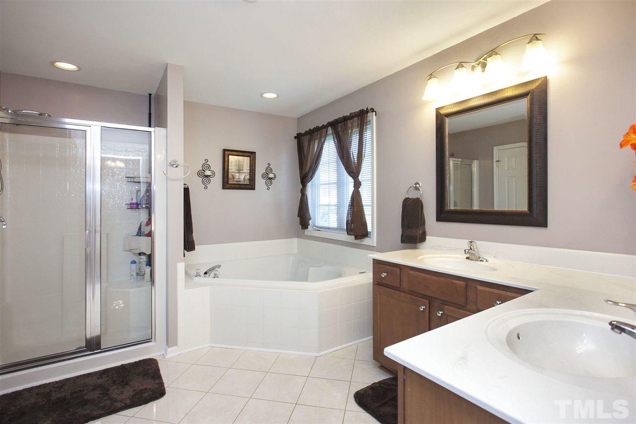 308 Inkster Cove Raleigh, NC 27603 - Photo 13 of 25 a bathroom with a tub sink and mirror