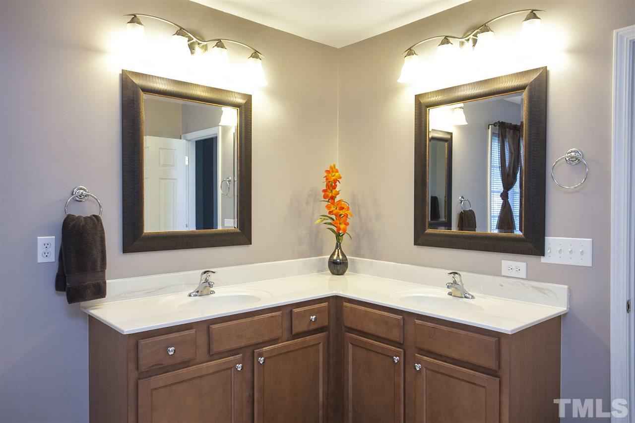 308 Inkster Cove Raleigh, NC 27603 - Photo 14 of 25 a bathroom with a double vanity sink and a mirror