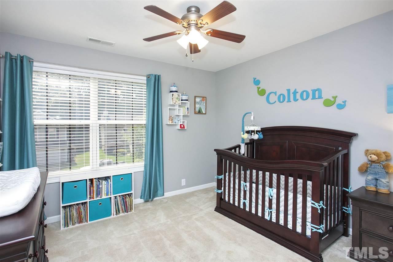 308 Inkster Cove Raleigh, NC 27603 - Photo 15 of 25 a bedroom with furniture and a window
