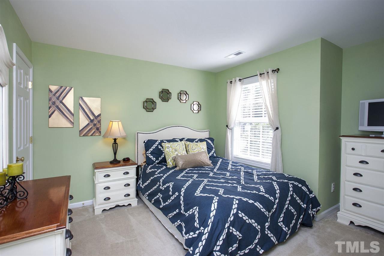 308 Inkster Cove Raleigh, NC 27603 - Photo 16 of 25 a bedroom with a bed and a television