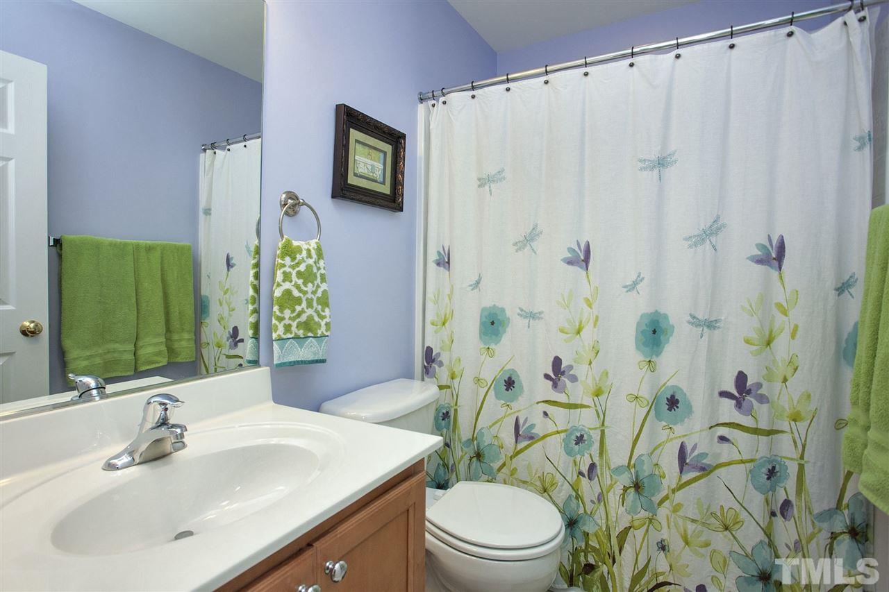 308 Inkster Cove Raleigh, NC 27603 - Photo 18 of 25 a bathroom with a sink a toilet and a mirror