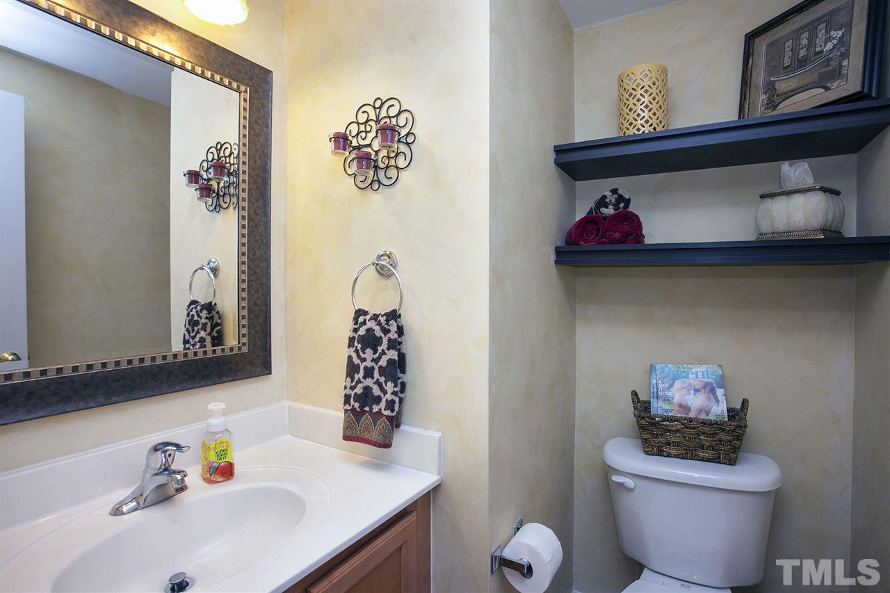 308 Inkster Cove Raleigh, NC 27603 - Photo 19 of 25 a bathroom with a toilet sink and mirror