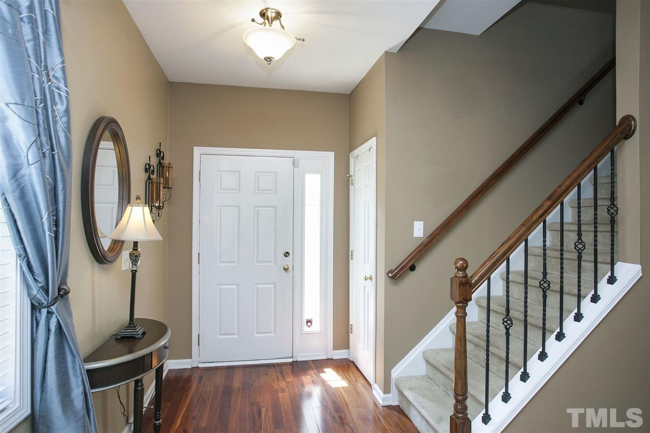 308 Inkster Cove Raleigh, NC 27603 - Photo 3 of 25 a view of a livingroom with wooden floor and staircase